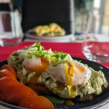 Poached eggs and avocado on toast with tomato