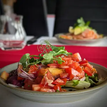 Bruschetta-style tomato salad with red onion and microgreens