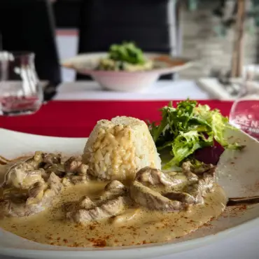 Creamy mushroom sauce over rice with a side salad