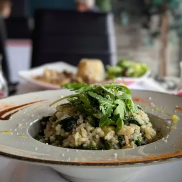 Spinach and pea risotto topped with rocket and parmesan