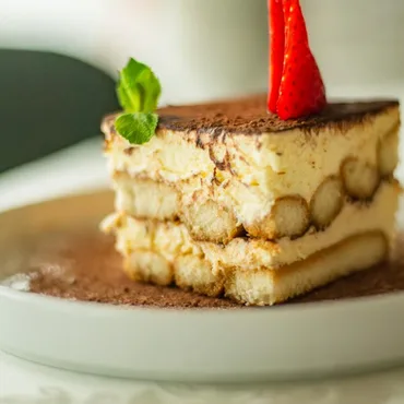 Slice of tiramisu with a strawberry garnish
