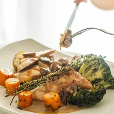 Chicken with mushroom sauce, roasted carrots and charred broccoli, plated tableside