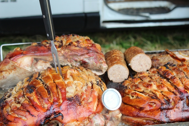A hog roast spread with crackling pork and sausages