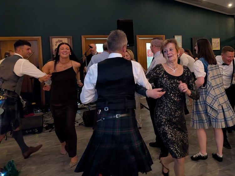 Guests ceilidh dancing at Hogmanay, with the live band playing