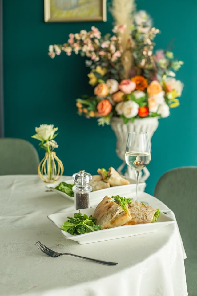 Table set with wine beneath the dining room flowers