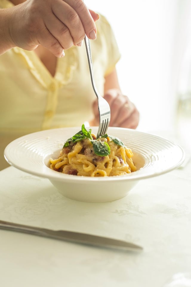 Twirling a fork through creamy tagliatelle