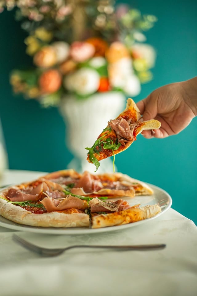 Prosciutto and arugula pizza, fresh from the oven