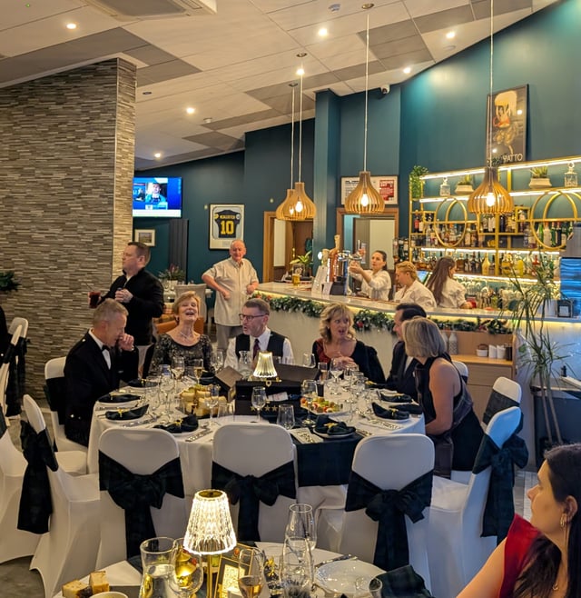 Guests at the bar before dinner, decorated for the festive season