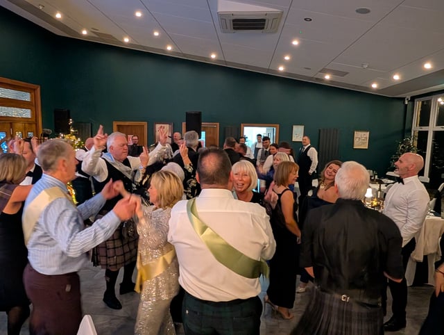 Guests dancing together as the band plays